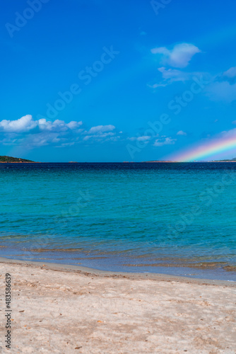 Tavolara Island, scenic view of island and full rainbow in a unique moment