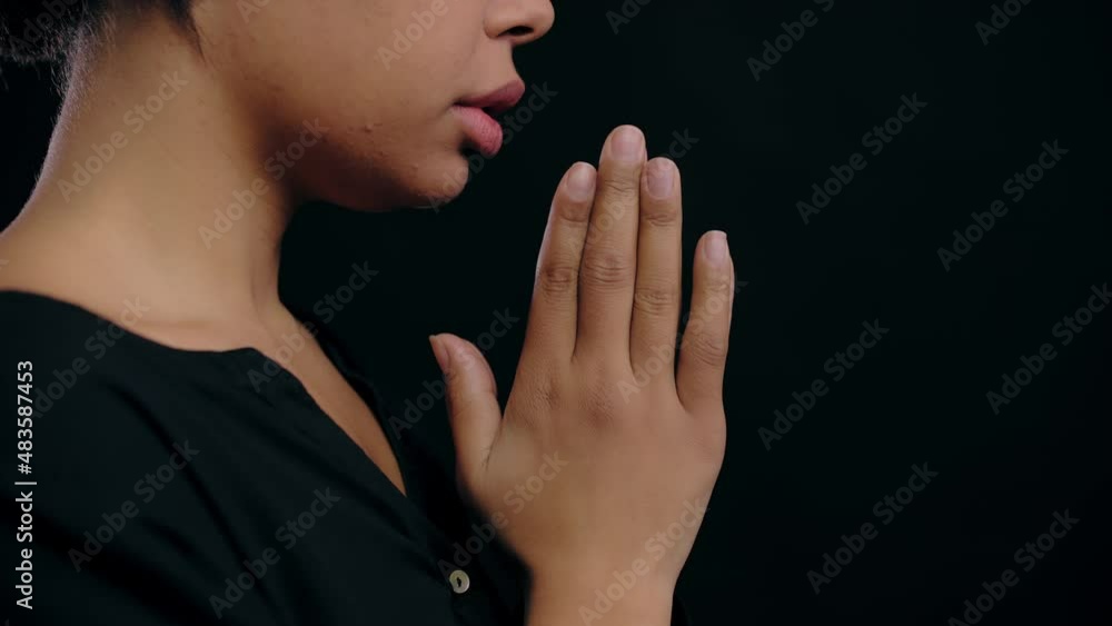 Biracial woman putting hands together in prayer to god religion and spirituality Biracial woman putting hands together in prayer to god religion and spirituality