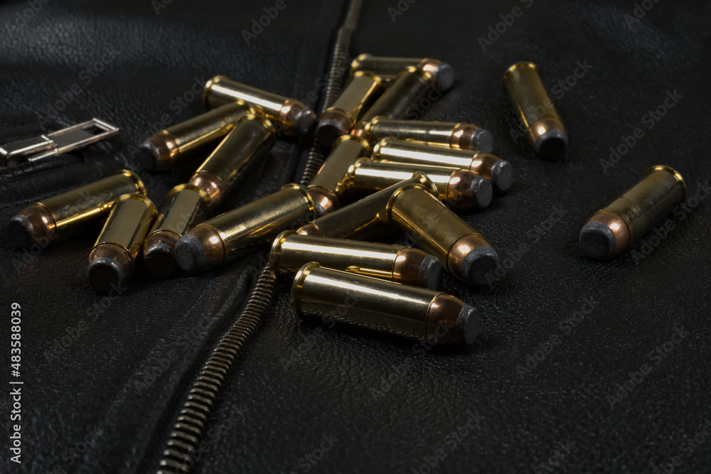 44 magnum ammunition, black leather jacket closeup 44 magnum ammunition, black leather jacket closeup