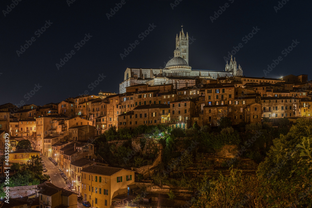 Night view of the Cathedral of Siena above the historic centre of Siena, Tuscany, Italy