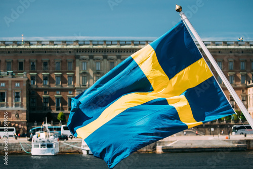 Canvas Print Stockholm, Sweden. Waving Swedish Flag In Stockholm Street.