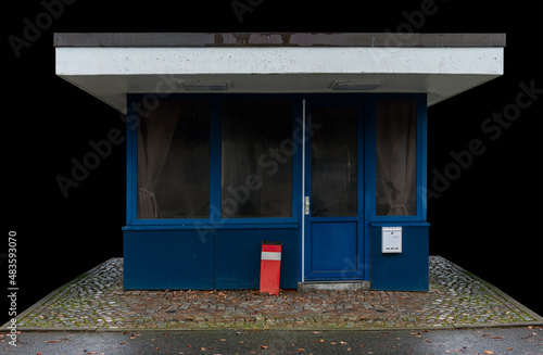 Photography blue closed gatehouse isolated on black background, many factories remain empty due to the coronavirus pandemic and the subsequent economic downturn 2022 in Germany