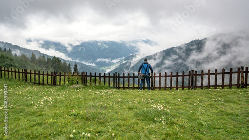 Man watching the Black Sea region mountains with clouds and dramatic skies. Green nature landscape of trees and forests in rural highlands of Black Sea Karadeniz region, Turkey