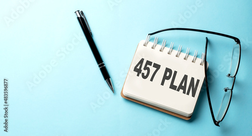 457 PLAN text written on a notepad on the blue background photo