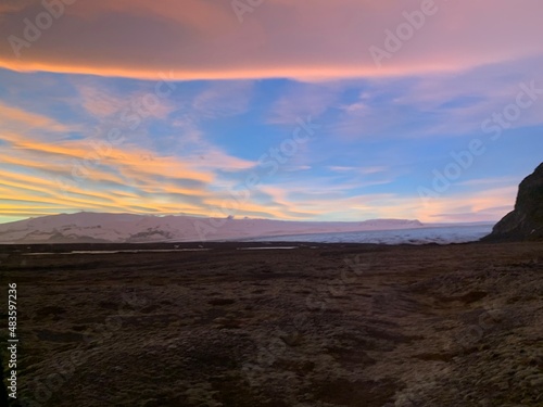 Sunsets in Iceland with snowy mountains in the background.