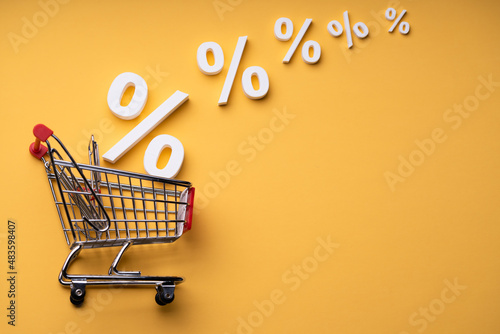 Sale Percents Falling Into Shopping Cart photo