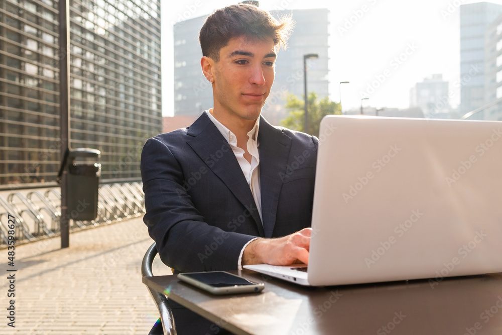 Young entrepreneur working on his laptop in a cafe. Digital entrepreneurship concept. Young entrepreneur working on his laptop in a cafe. Digital entrepreneurship concept.