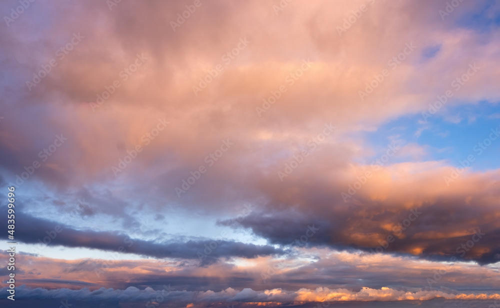 Beautiful colorful of blue sky with white and pink clouds during summer sunrise or sunset.
