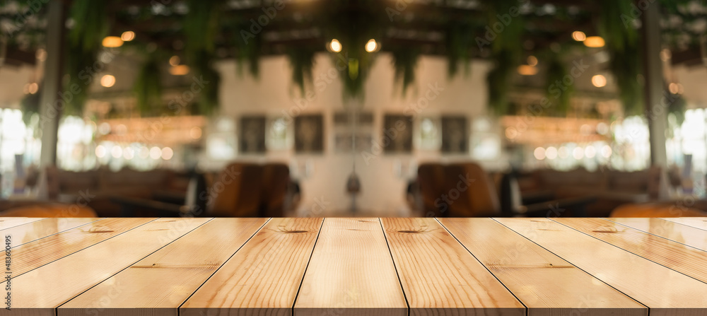 Empty wooden table top with lights bokeh on blur restaurant background. Empty wooden table top with lights bokeh on blur restaurant background.