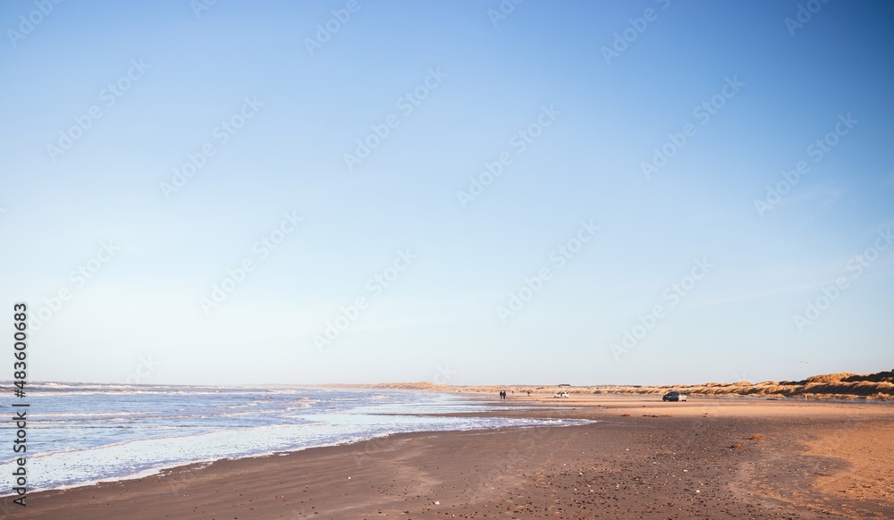 Evening landscape of North Sea beach at Blokhus at sunset of pastel colors. Nordjylland (North Jutland Region), Denmark