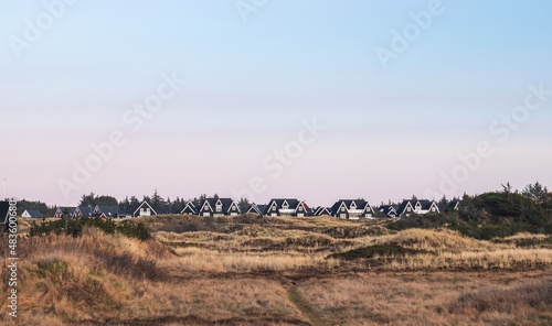 Obraz na płótnie Residential houses in the dunes of Blokhus Strand beach, North Denmark Region w salonie