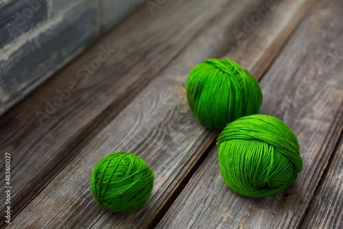 Balls of green yarn on wooden background.Copyspace. hobby