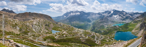 Idyllic blue alpine lake high up on the mountains, scenic landscape rocky terrain at high altitude on the Alps, panoramic view