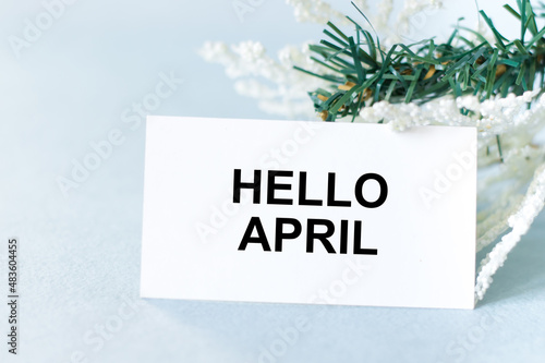 HELLO APRIL text on a card on a light background