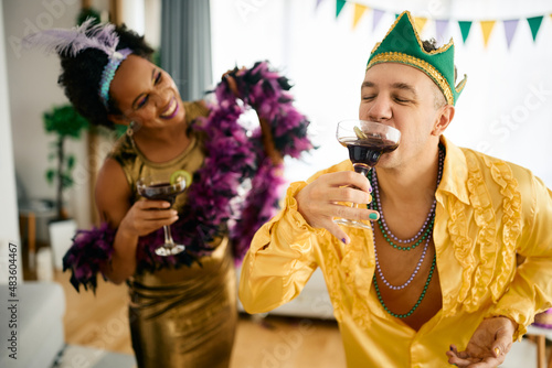 Photography Happy man having a drink on party during Mardi Gras celebration.