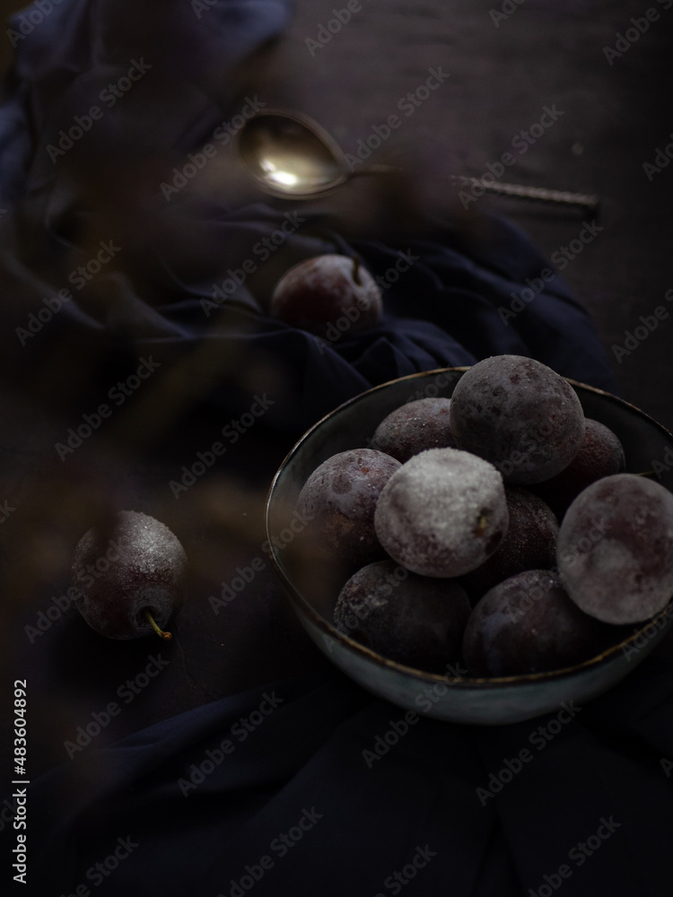 Obraz premium Plum on a dark table.