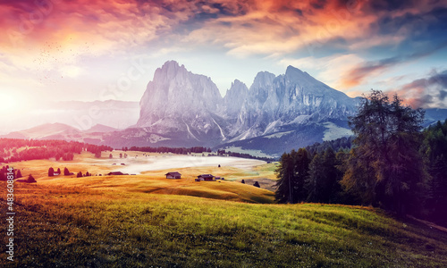 Incredible Nature Landscape. Awesome Dolomites Alps during sunrise. Fairytale green alpine plateau Seiser Alm (Alpe di Siusi) with Langkofel mountain at sunrise, Italy. Popular travel destination.