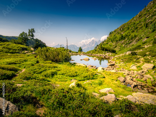 Scenic mountain landscape with mountain lake,mountain peaks,stones,trees,blue sky.Summer landscape,watter. Blue. Schladminger tauern,Alps,Austria. . photo