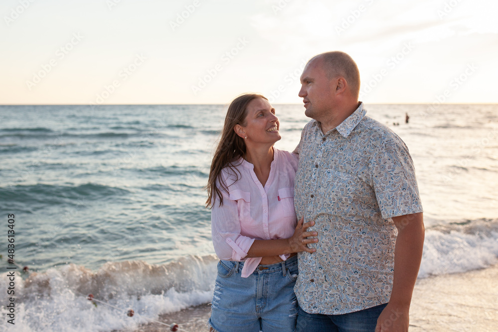 Happy couple near sea on sunny summer day