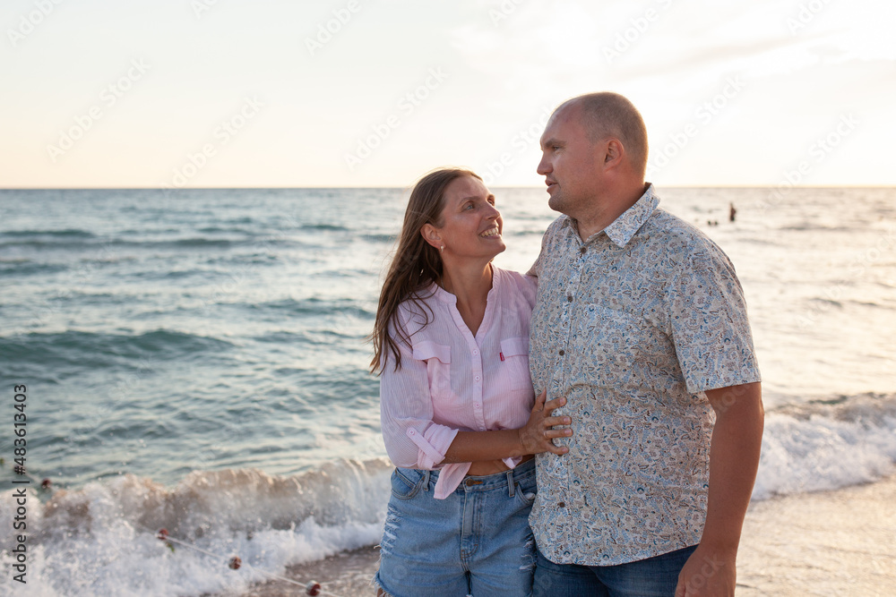 Happy couple near sea on sunny summer day Happy couple near sea on sunny summer day