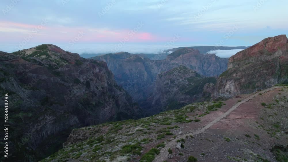 flying in Madeira mountains in the morning at sunrise, awesome volcanic rocky mountain ridge, extreme terrain for hiking, Madeira landmark Pico do Arieiro flying in Madeira mountains in the morning at sunrise, awesome volcanic rocky mountain ridge, extreme terrain for hiking, Madeira landmark Pico do Arieiro