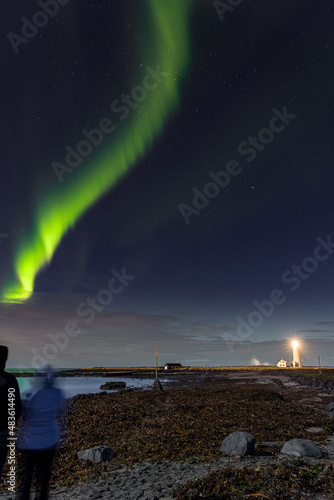 Aurora Borealis displaying above Grotta Island lighthouse in the city of Reykjavík , Iceland