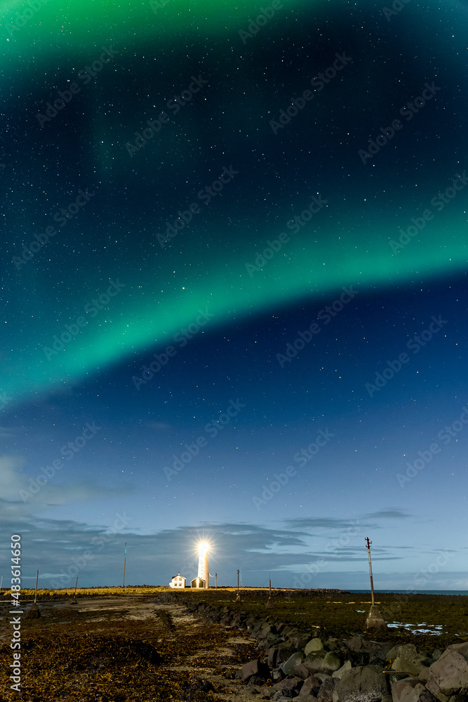 Northern Lights displaying above Grotta Island Lighthouse in the Icelandic capital, Reykjavík