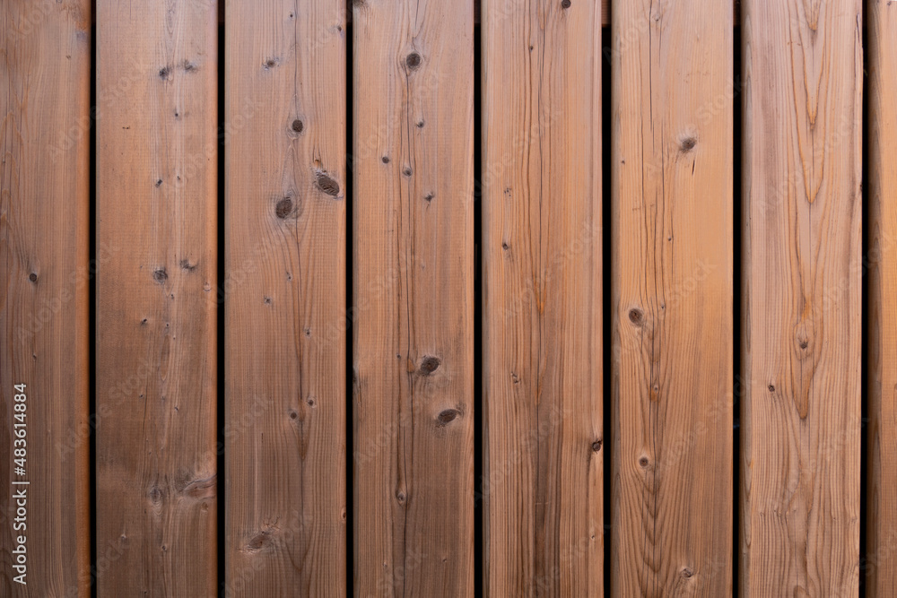 Fototapeta premium vertical painted orange wood background texture with knots straight on wooden deck boards