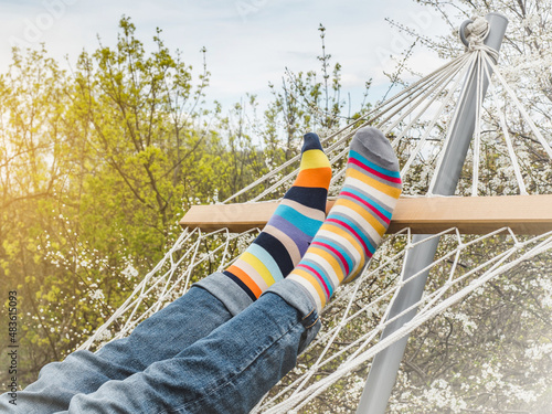 Men's legs and bright socks. Close-up, outdoor. Style, beauty and elegance concept