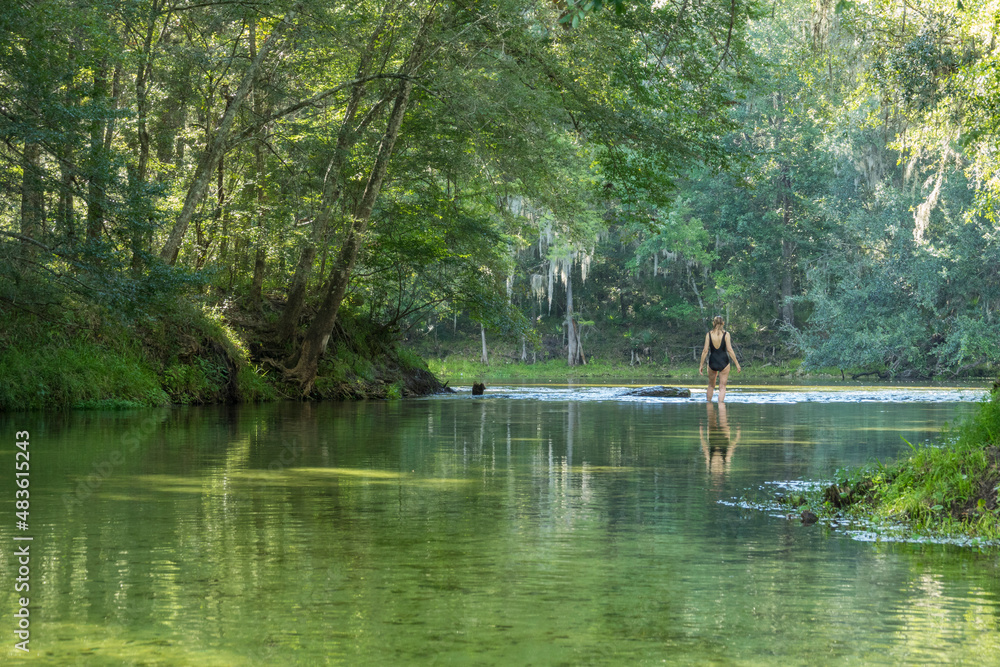 Mature woman wading where Poe Springs run meets the Santa Fe River, Gilchrist County, Florida Mature woman wading where Poe Springs run meets the Santa Fe River, Gilchrist County, Florida