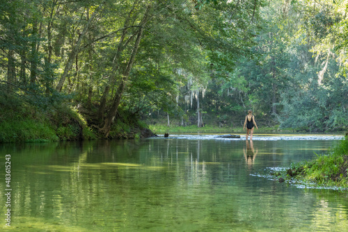 Mature woman wading where Poe Springs run meets the Santa Fe River, Gilchrist County, Florida