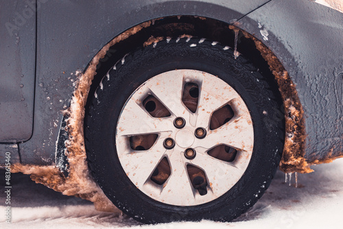 car covered with snow and icicles in winter