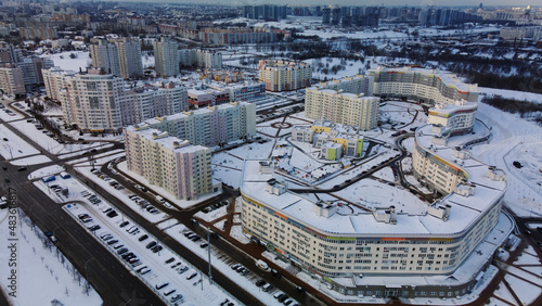 Construction site of a modern city block. High-rise buildings under construction. Construction tower cranes. Construction site in winter. Aerial photography at sunset.
