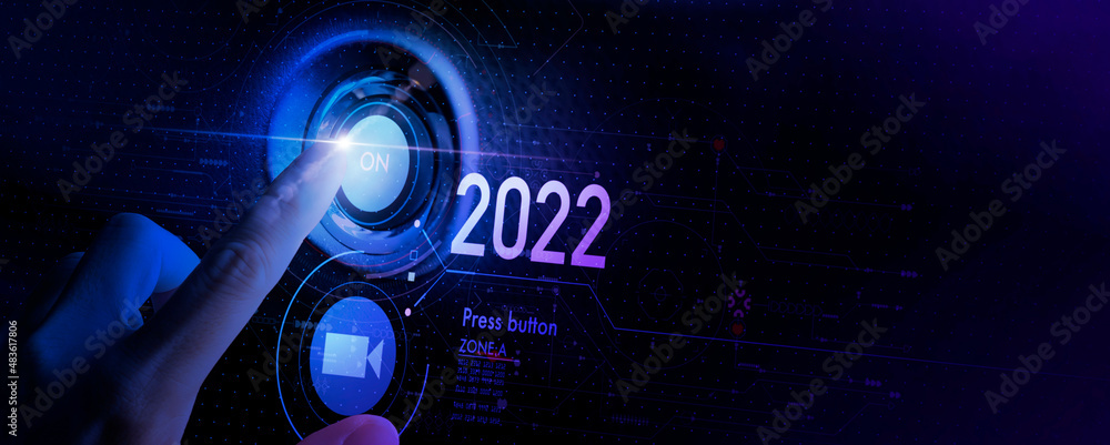 Hand pushing On 2022 and Start 2022. Happy New Year button technology virtual innovation concept.