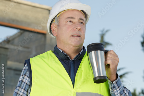 senior engineer man having coffee outdoors