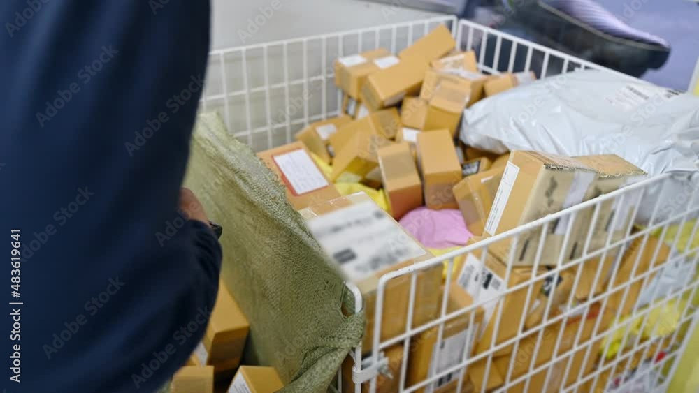 Delivery man scanning cardboard parcel from distribution center Delivery man scanning cardboard parcel from distribution center