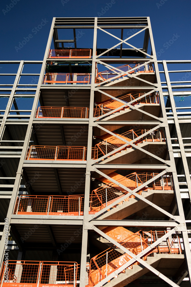 construction of a new inner city  multi storey car-park showing the unfinished steel girder stairwell shot from below converging verticals
