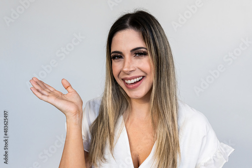 A young Latin girl points to the sides. Advertisement and presentation concept.