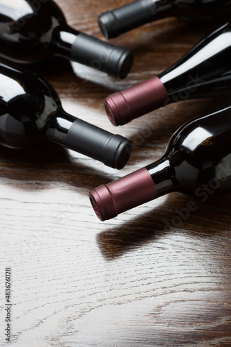 Various Wine Bottles on a Reflective Wood Surface Abstract.