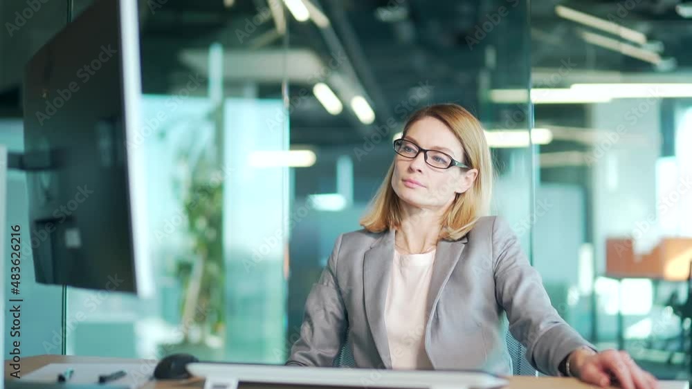 Successful well done work woman office satisfied young business worker finished computer work stretching sitting at workplace desk. confident thinking female employee accountant to complete job on pc Successful well done work woman office satisfied young business worker finished computer work stretching sitting at workplace desk. confident thinking female employee accountant to complete job on pc