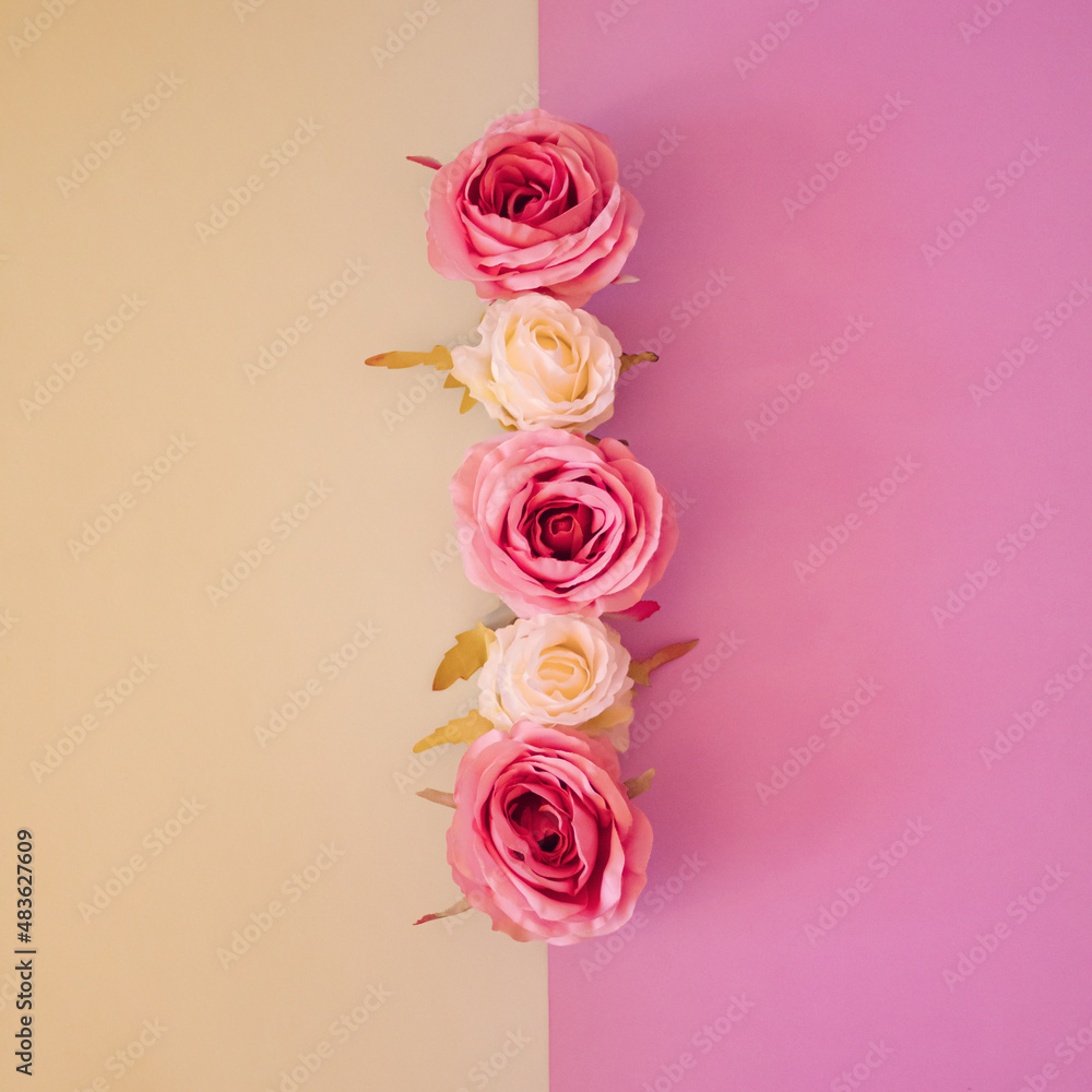 Flowers composition. Rose flowers on pastel pink and yellow background. Flowers composition. Rose flowers on pastel pink and yellow background.