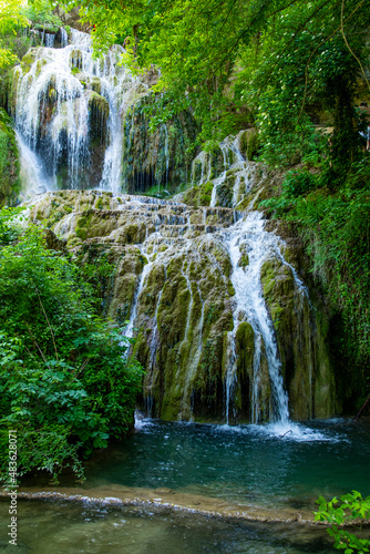 Stunning waterfalls and a blue lagoon lake in the small village Krushuna, Bulgaria. The Krushunski waterfalls. Beautiful landscape in summer.