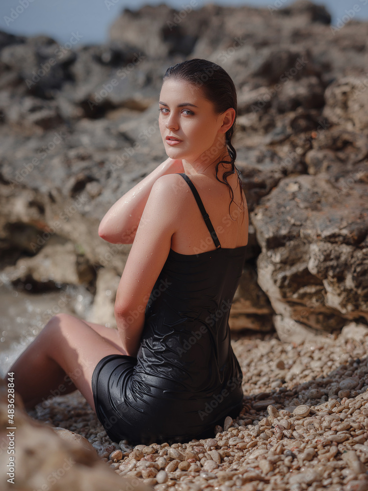 lifestyle swimwear photo-shoot of beautifaul woman on rocky beach