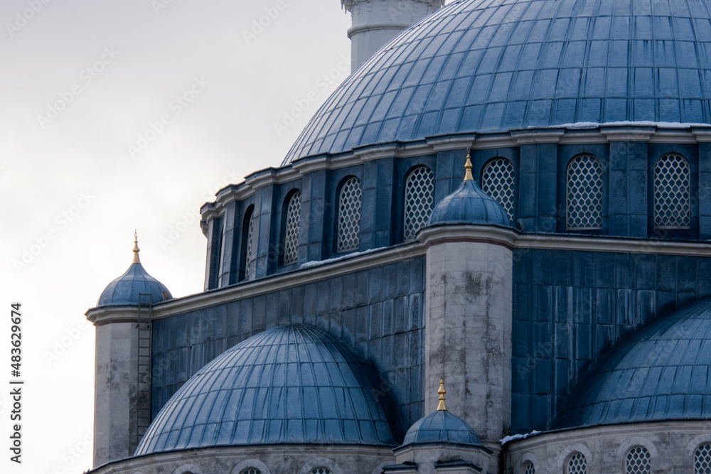 Fototapeta premium A mosque in Ottoman architecture. Minarets and dome of the mosque. Selective focus.