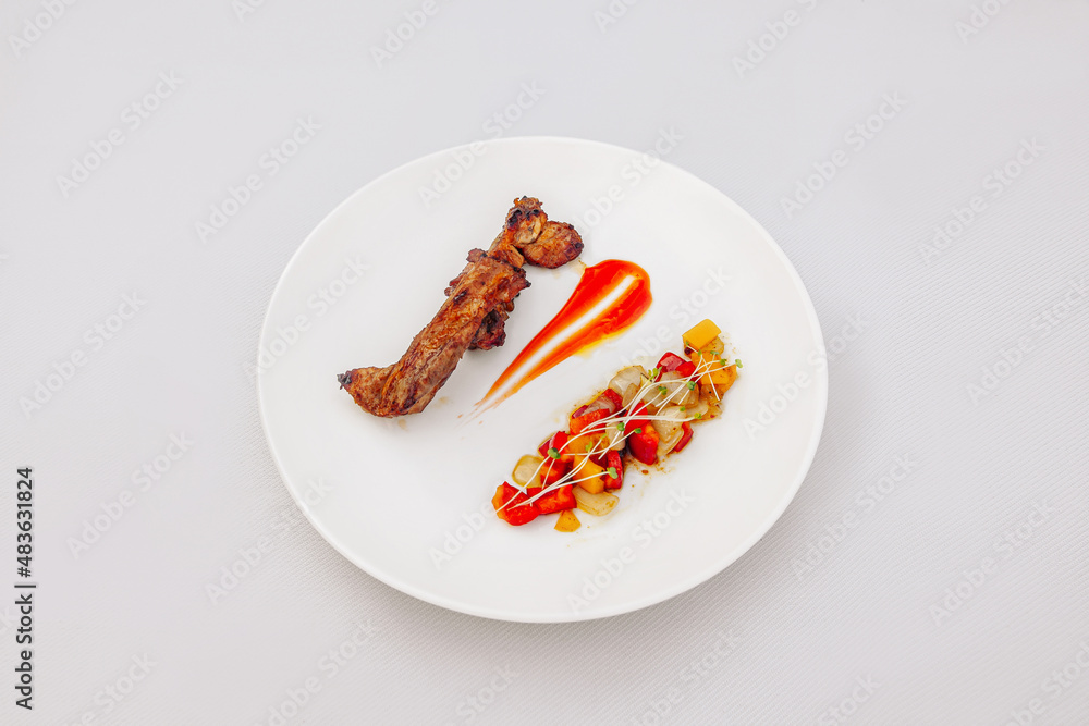 Grilled pork ribs with chili sauce, vegetable salad, isolated on white background, top view Grilled pork ribs with chili sauce, vegetable salad, isolated on white background, top view
