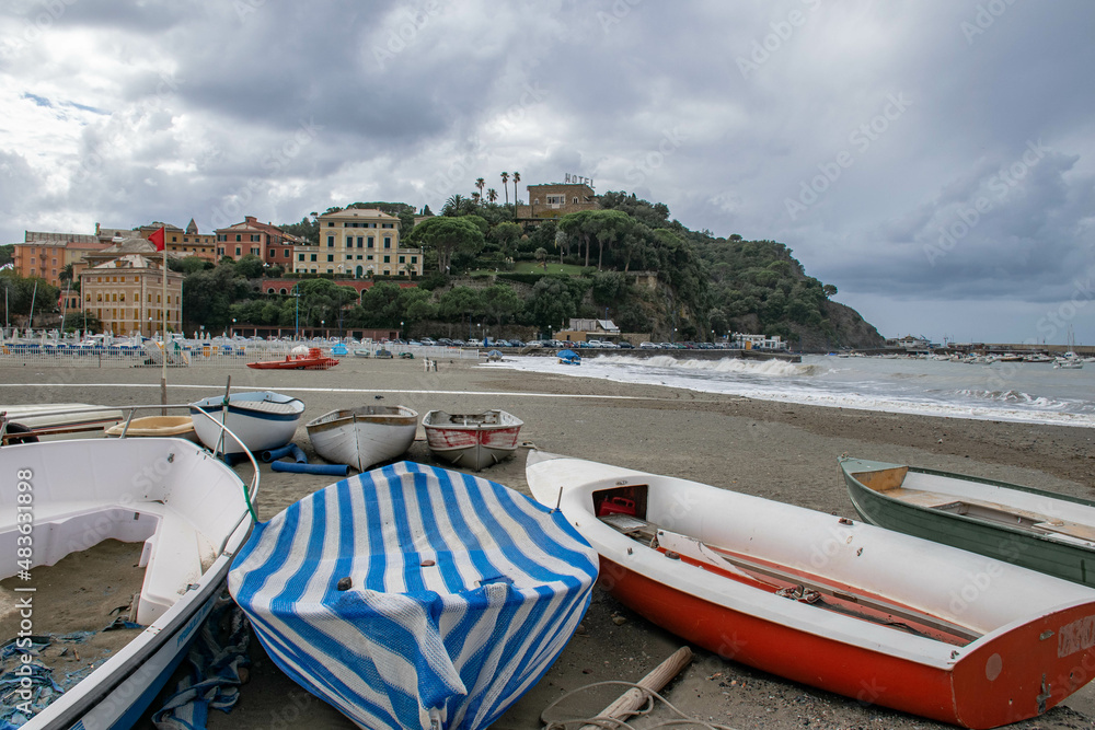 Cinque Terre, Sestri Levante, Italy, Liguria, September 2017. boats on a deserted beach, sea view, bay and cloudy sky