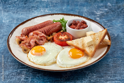 traditional breakfast with egg and sausages photo