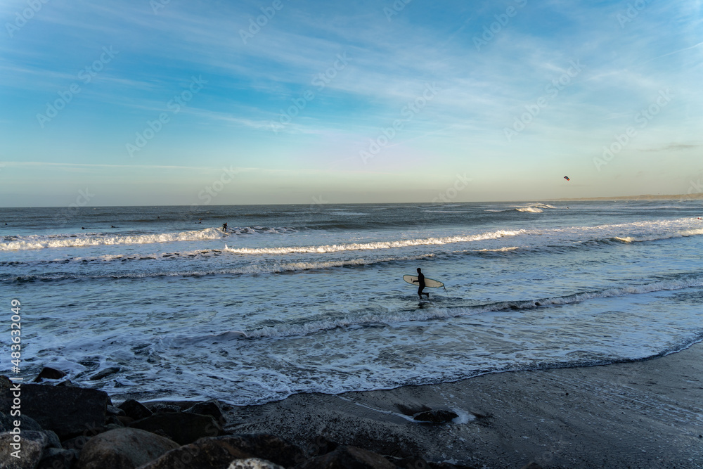 Surfer catching waves in cold water in winter, cold hawaii, norre vorupor, Klitmoller and Hanstholm, denmark