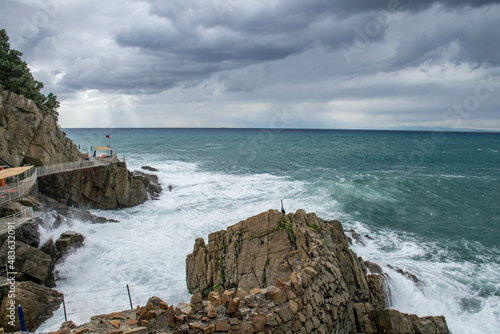 Cinque Terre, Sestri Levante, Italy, Liguria, September 2015. stormy sea, rocky coast and cloudy sky