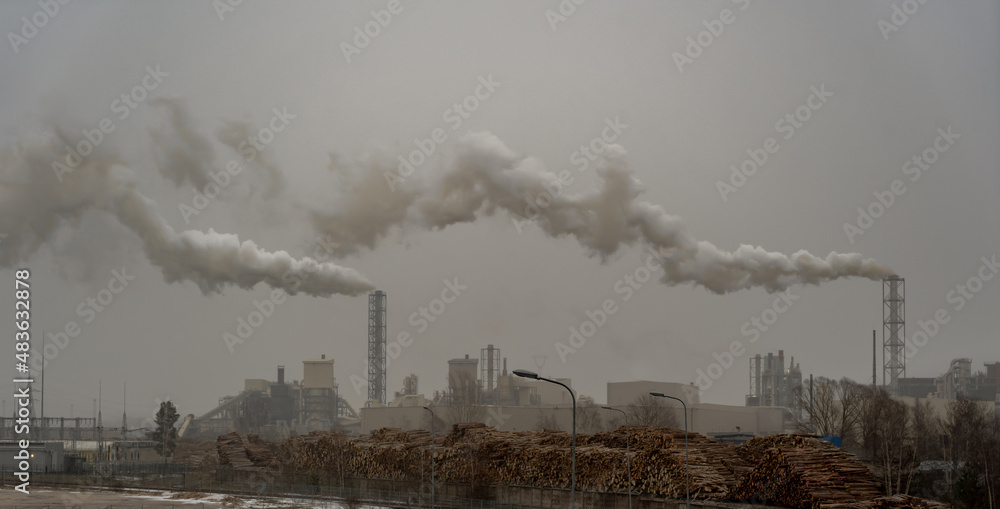 Industrial industrial zone chimneys with smoke in cloudy weather